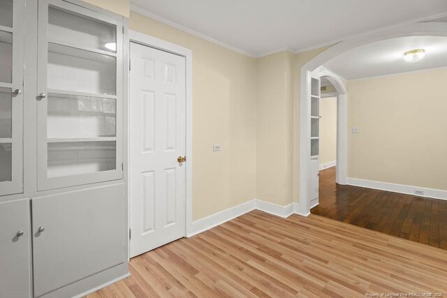 1007 Jenkins St, Lumberton, NC 28358 - corridor with wood finished floors, arched walkways, and ornamental molding