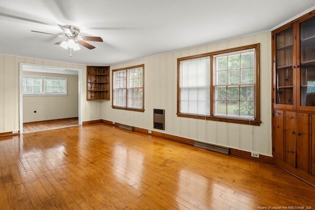 1007 Jenkins St, Lumberton, NC 28358 - spare room with a ceiling fan, heating unit, hardwood / wood-style flooring, and plenty of natural light