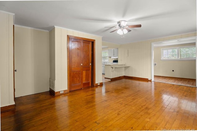 1007 Jenkins St, Lumberton, NC 28358 - unfurnished living room featuring wood-type flooring, a ceiling fan, and ornamental molding