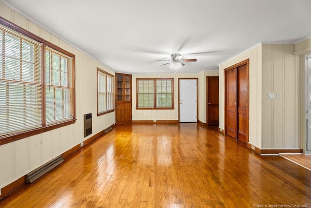 1007 Jenkins St, Lumberton, NC 28358 - unfurnished room with hardwood / wood-style floors, ceiling fan, crown molding, and heating unit