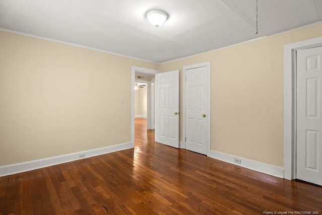 1007 Jenkins St, Lumberton, NC 28358 - unfurnished bedroom with attic access, crown molding, and wood-type flooring