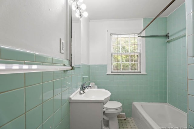 1007 Jenkins St, Lumberton, NC 28358 - bathroom featuring vanity, crown molding, a wainscoted wall, tile walls, and shower / washtub combination