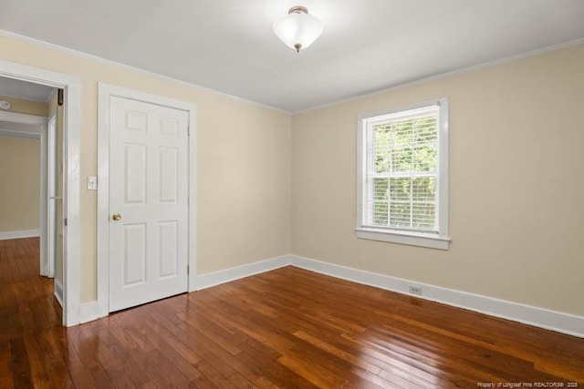 1007 Jenkins St, Lumberton, NC 28358 - spare room featuring ornamental molding and wood-type flooring