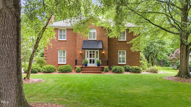 441 Fieldstone Dr, Burlington, NC 27215 - view of front of home featuring a front yard, brick siding, and a chimney