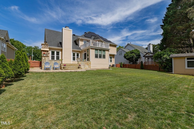 8913 Walking Stick Trl, Raleigh, NC 27615 - back of property featuring a balcony, a chimney, a patio, and a shingled roof