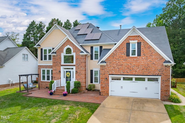 8913 Walking Stick Trl, Raleigh, NC 27615 - traditional-style house with brick siding, solar panels, a front yard, concrete driveway, and a garage