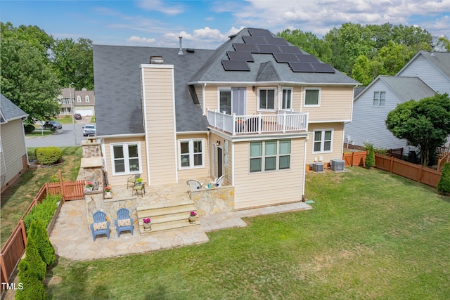 8913 Walking Stick Trl, Raleigh, NC 27615 - rear view of house with solar panels, a balcony, a chimney, a patio area, and central air condition unit