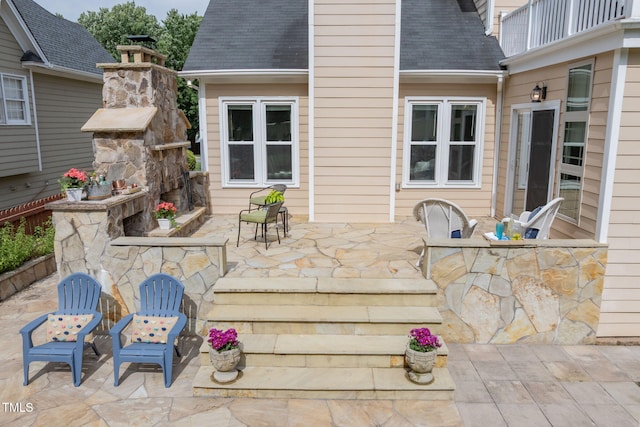 8913 Walking Stick Trl, Raleigh, NC 27615 - view of patio / terrace featuring an outdoor stone fireplace and a balcony