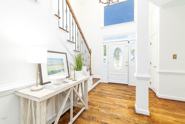 8913 Walking Stick Trl, Raleigh, NC 27615 - entryway with stairs, wood finished floors, a chandelier, and a towering ceiling