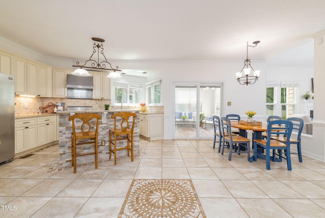 8913 Walking Stick Trl, Raleigh, NC 27615 - dining space featuring light tile patterned floors, a chandelier, and ornamental molding