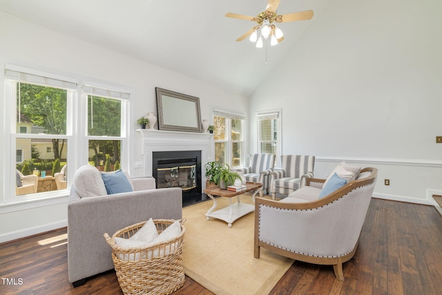 8913 Walking Stick Trl, Raleigh, NC 27615 - living room featuring a ceiling fan, a fireplace with flush hearth, dark wood-style flooring, high vaulted ceiling, and baseboards