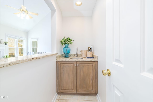 8913 Walking Stick Trl, Raleigh, NC 27615 - indoor wet bar featuring baseboards, ceiling fan, light tile patterned floors, and vaulted ceiling