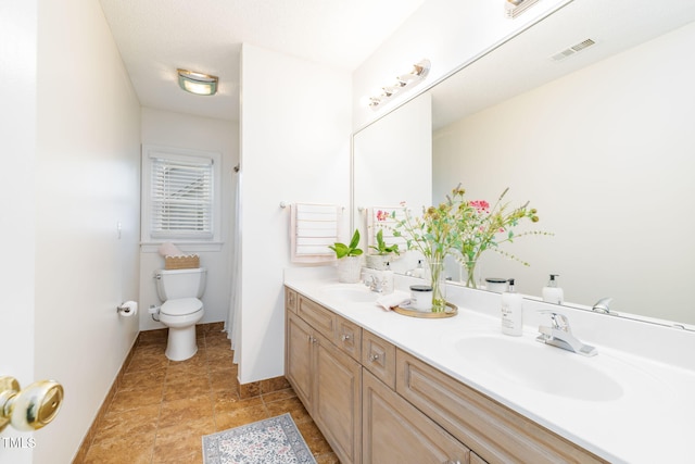 8913 Walking Stick Trl, Raleigh, NC 27615 - full bath with double vanity, toilet, and baseboards