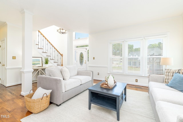 8913 Walking Stick Trl, Raleigh, NC 27615 - living room with wood finished floors, ornamental molding, stairs, decorative columns, and baseboards