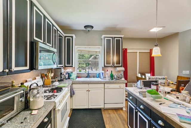 10205 Sorrills Creek Ln, Raleigh, NC 27614 - kitchen featuring white appliances, a sink, light countertops, and decorative light fixtures