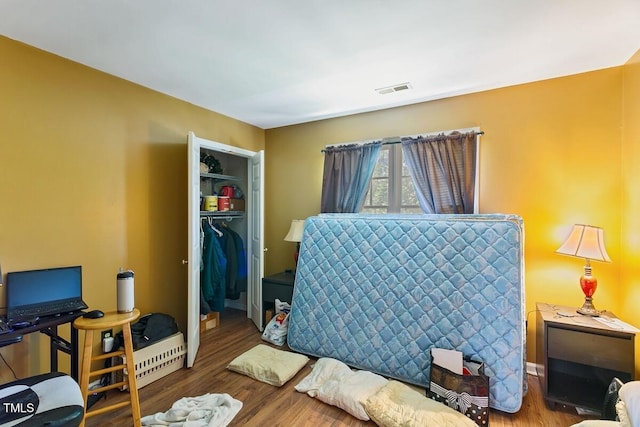 10205 Sorrills Creek Ln, Raleigh, NC 27614 - bedroom featuring wood finished floors, a closet, and a walk in closet