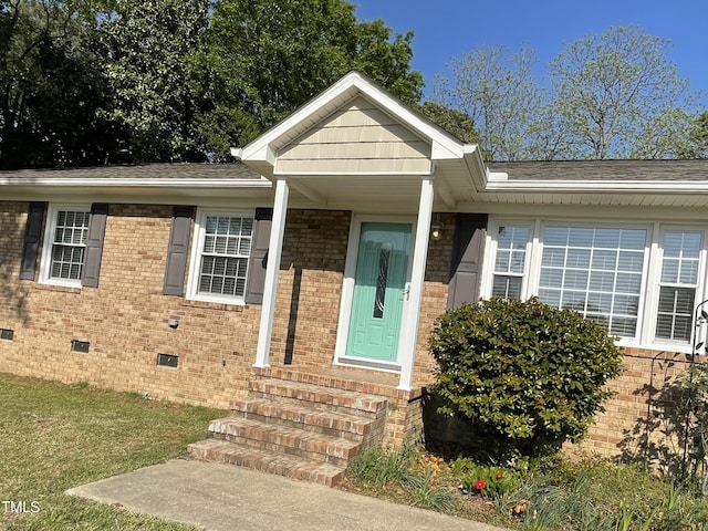 305 Briarcliff Dr, Dunn, NC 28334 - entrance to property featuring crawl space, brick siding, a lawn, and a shingled roof