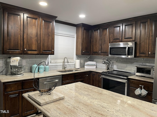 305 Briarcliff Dr, Dunn, NC 28334 - kitchen featuring stainless steel appliances, a sink, dark brown cabinets, decorative backsplash, and light stone countertops