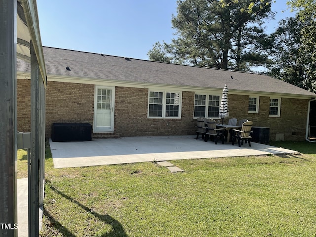 305 Briarcliff Dr, Dunn, NC 28334 - back of property featuring brick siding, a patio area, a lawn, and a shingled roof