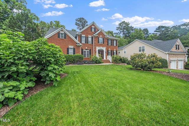 112 Sterling Ridge Way, Cary, NC 27519 - colonial-style house featuring brick siding and a front lawn