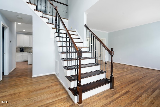 112 Sterling Ridge Way, Cary, NC 27519 - stairs with wood finished floors and baseboards