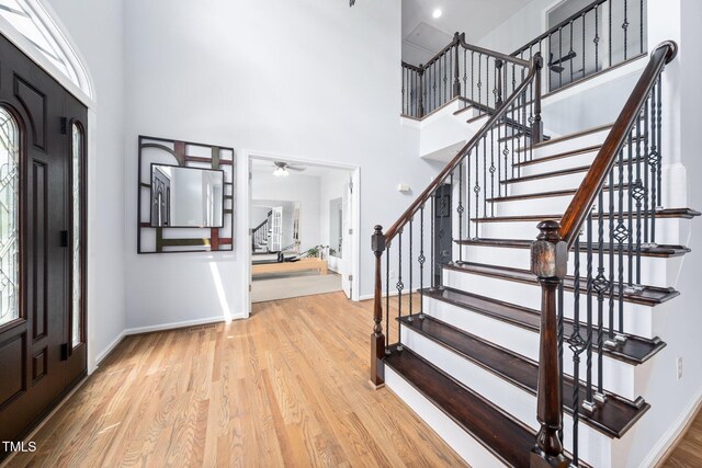 112 Sterling Ridge Way, Cary, NC 27519 - foyer featuring stairs, a high ceiling, baseboards, wood finished floors, and ceiling fan