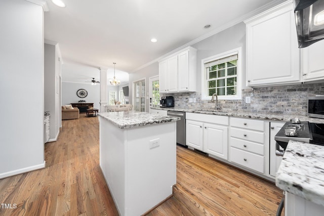112 Sterling Ridge Way, Cary, NC 27519 - kitchen featuring dishwasher, a sink, a kitchen island, ornamental molding, and decorative backsplash