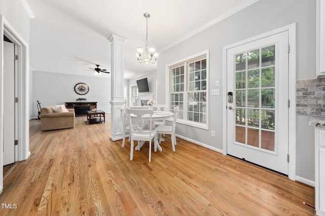 112 Sterling Ridge Way, Cary, NC 27519 - dining room featuring decorative columns, light wood finished floors, crown molding, ceiling fan, and a chandelier