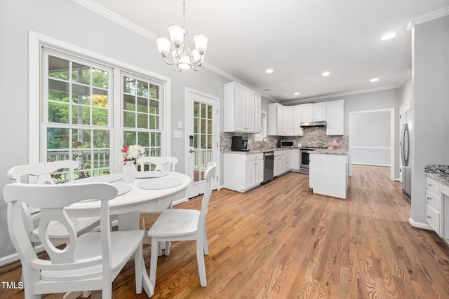 112 Sterling Ridge Way, Cary, NC 27519 - kitchen featuring stainless steel appliances, ornamental molding, backsplash, under cabinet range hood, and a chandelier