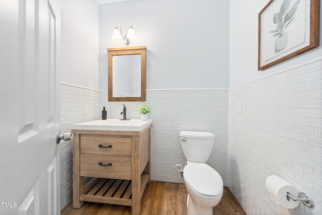 112 Sterling Ridge Way, Cary, NC 27519 - half bathroom featuring toilet, a wainscoted wall, vanity, wood finished floors, and tile walls
