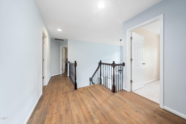 112 Sterling Ridge Way, Cary, NC 27519 - hall with an upstairs landing, wood finished floors, recessed lighting, and baseboards