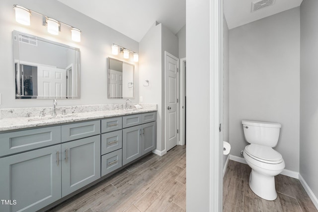 112 Sterling Ridge Way, Cary, NC 27519 - full bathroom featuring double vanity, wood finished floors, toilet, and baseboards
