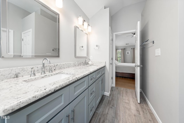 112 Sterling Ridge Way, Cary, NC 27519 - ensuite bathroom featuring wood finished floors, double vanity, ceiling fan, vaulted ceiling, and baseboards
