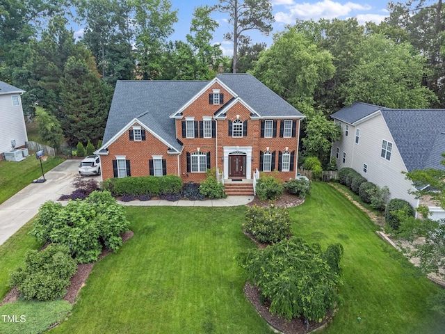 112 Sterling Ridge Way, Cary, NC 27519 - colonial home featuring concrete driveway, brick siding, and a front lawn