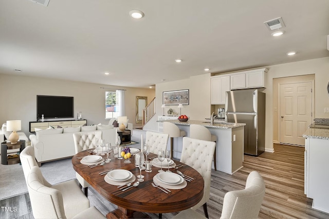 2700 Barrington Dr, Raleigh, NC 27610 - dining room with stairs, wood finished floors, recessed lighting, and baseboards