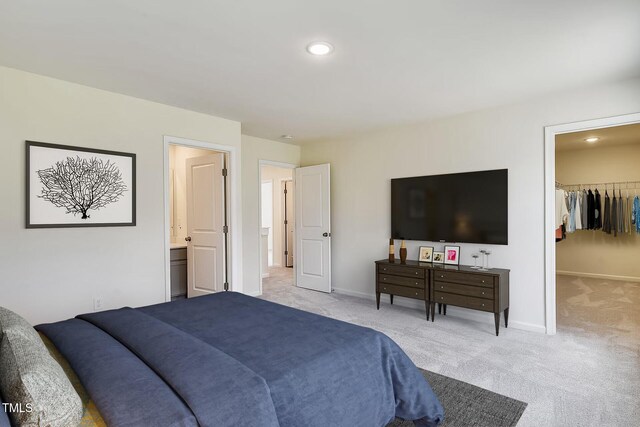 2700 Barrington Dr, Raleigh, NC 27610 - bedroom with light carpet, a spacious closet, baseboards, and recessed lighting