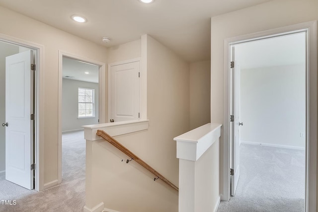2700 Barrington Dr, Raleigh, NC 27610 - hall with an upstairs landing, light carpet, baseboards, and recessed lighting