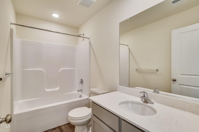 2700 Barrington Dr, Raleigh, NC 27610 - bathroom featuring vanity, toilet, wood finished floors, shower / tub combination, and recessed lighting