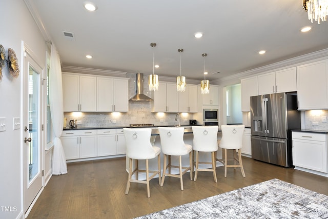 609 Ramsours Mill Dr, Holly Springs, NC 27540 - kitchen featuring stainless steel appliances, wall chimney exhaust hood, decorative backsplash, dark wood-style flooring, and recessed lighting