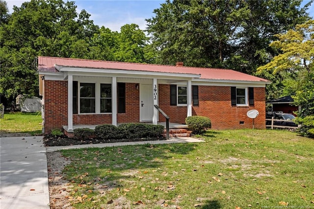 3902 Hartwell Rd, Fayetteville, NC 28304 - ranch-style house featuring brick siding, a front lawn, covered porch, metal roof, and a chimney