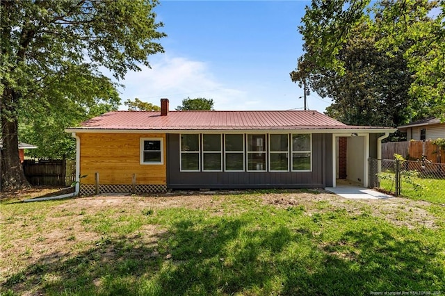3902 Hartwell Rd, Fayetteville, NC 28304 - rear view of house featuring a chimney and metal roof