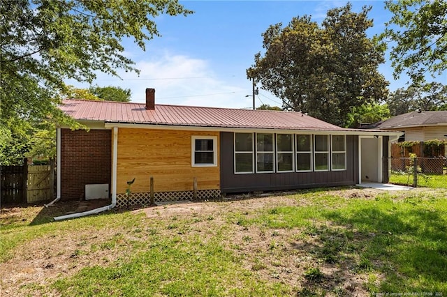 3902 Hartwell Rd, Fayetteville, NC 28304 - rear view of property featuring metal roof, a chimney, and brick siding