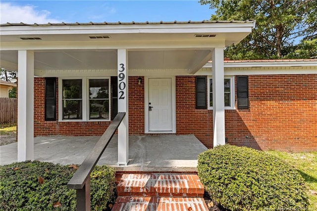 3902 Hartwell Rd, Fayetteville, NC 28304 - doorway to property featuring brick siding and a porch