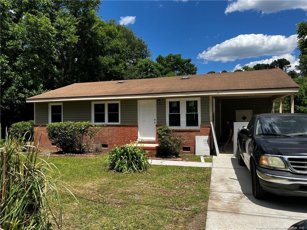 117 Leona Ave, Fayetteville, NC 28314 - single story home with crawl space, an attached carport, brick siding, a front yard, and concrete driveway