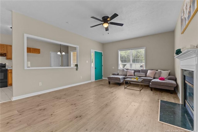 926 Foxhunt Ln, Fayetteville, NC 28314 - living area with light wood-type flooring, a fireplace with flush hearth, ceiling fan, and a chandelier