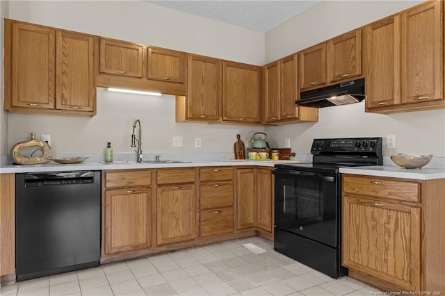 926 Foxhunt Ln, Fayetteville, NC 28314 - kitchen featuring black appliances, under cabinet range hood, a sink, light countertops, and brown cabinets