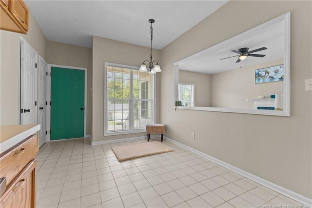 926 Foxhunt Ln, Fayetteville, NC 28314 - unfurnished dining area featuring a ceiling fan, a chandelier, light tile patterned floors, and baseboards