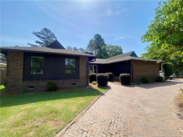 4207 Aldwych St, Lumberton, NC 28358 - view of front of house with crawl space, a front yard, brick siding, and board and batten siding