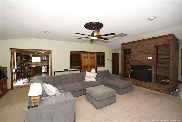 4207 Aldwych St, Lumberton, NC 28358 - carpeted living area with vaulted ceiling, a ceiling fan, a brick fireplace, and a sink