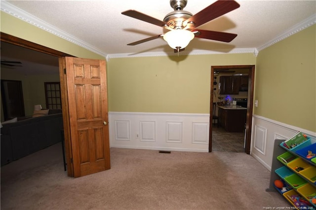 4207 Aldwych St, Lumberton, NC 28358 - bedroom featuring crown molding, carpet floors, a wainscoted wall, and ceiling fan